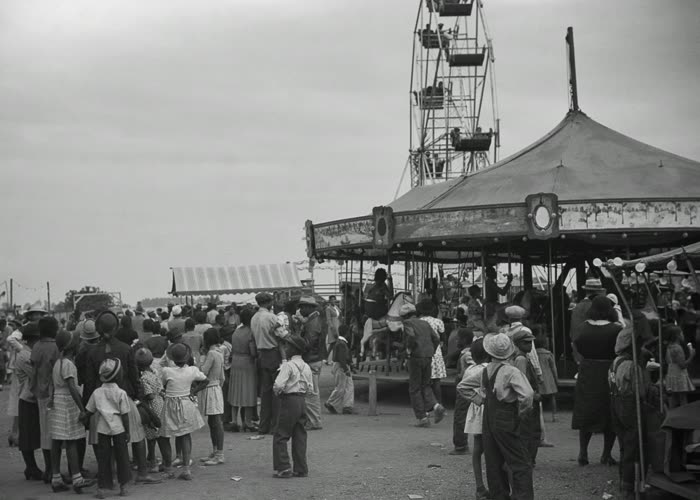 The crowded midway in front of the carousel
